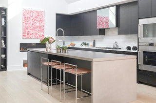 White, gray, and beige kitchen with custom concrete countertops in a waterfall style.