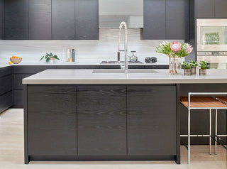 White and gray kitchen with griege custom concrete countertop on the island.