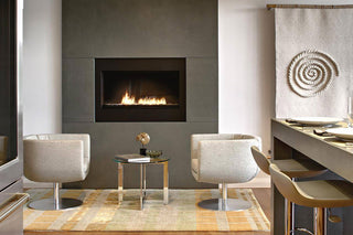 Cozy kitchen with concrete fireplace surround in the corner.